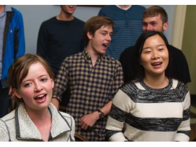 photograph of members of the Yale Glee Club singing together in rehearsal